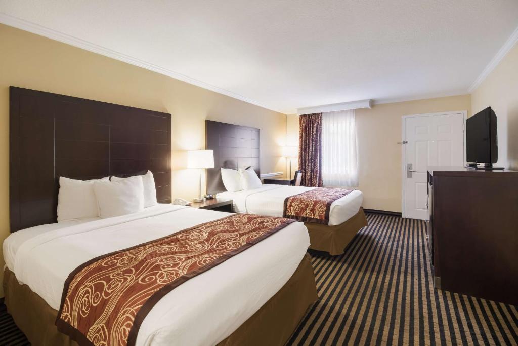 a hotel room with two beds and a television at Best Western - McKenzie in McKenzie