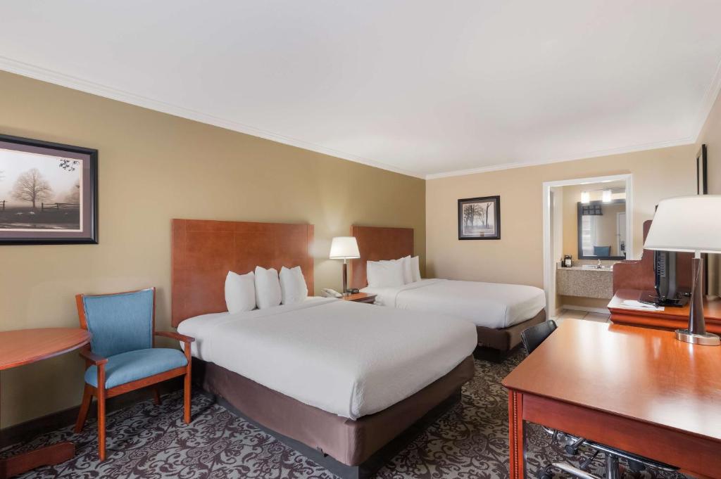 a hotel room with two beds and a desk at Best Western Conway in Conway