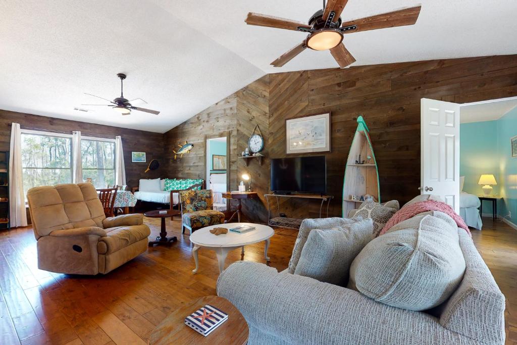 a living room with a couch and a ceiling fan at Our Anchor in St. George Island