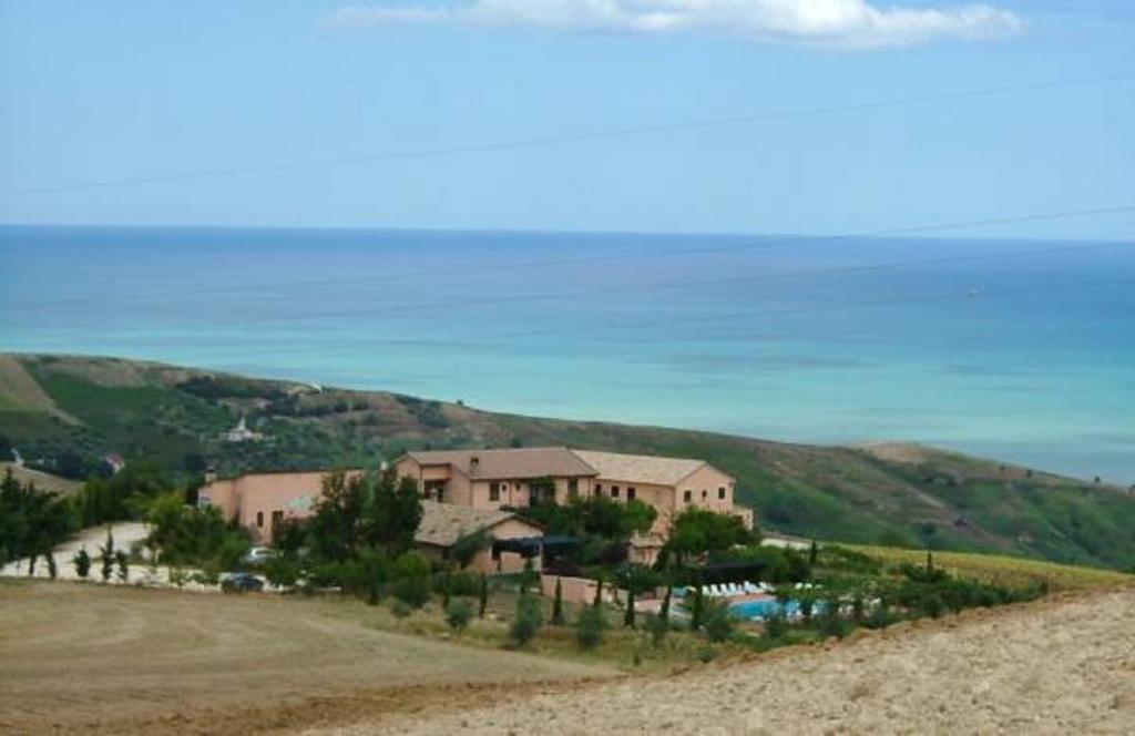 a house on top of a hill next to the ocean at Agriturismo Le Macine in Silvi Marina
