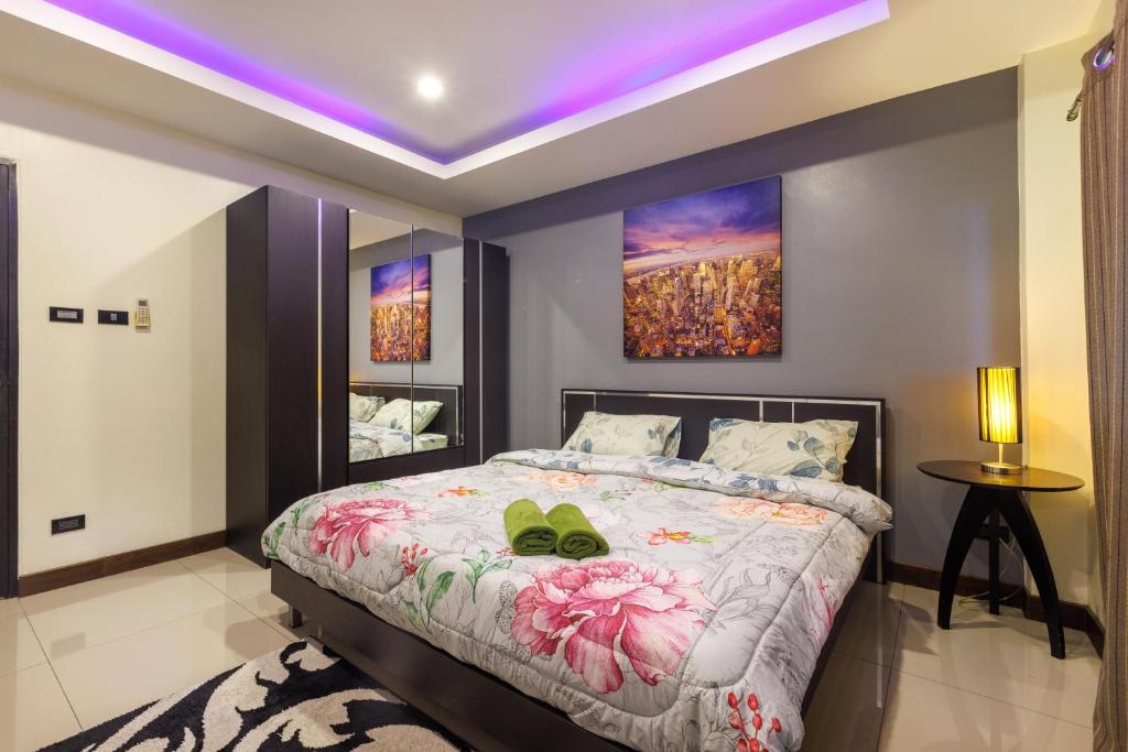 a bedroom with a bed with a purple ceiling at Kanokkan Apartment in Hua Hin