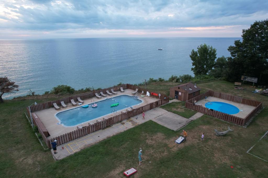 an overhead view of a swimming pool next to the water at Lake Bluff Inn and Suites in South Haven