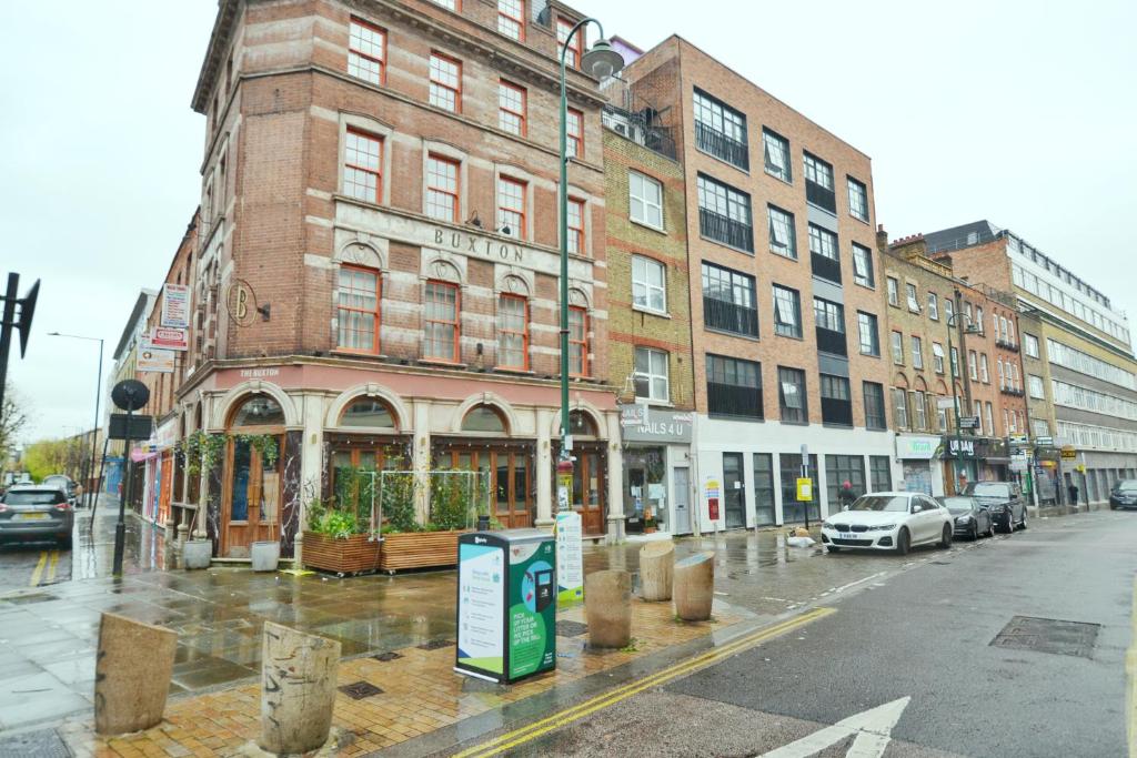 a building on a city street in the rain at The Osborn at Brick Lane in London