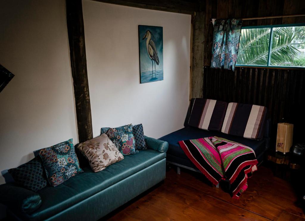 a living room with a couch and a window at Aquelarre in La Capuera