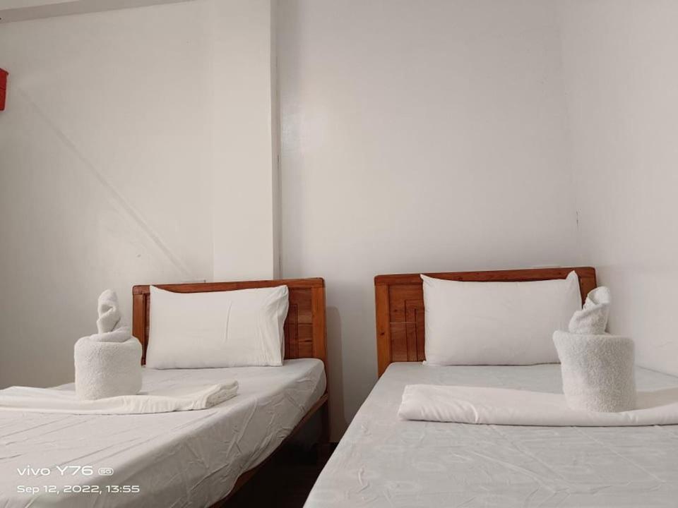 two beds sitting next to each other in a room at RSK Beach and Accommodation in Dapa