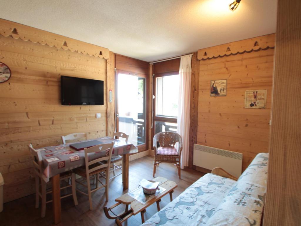 a living room with a table and a room with a bed at Appartement Les Carroz d'Arâches, 2 pièces, 4 personnes - FR-1-572-87 in Arâches-la-Frasse