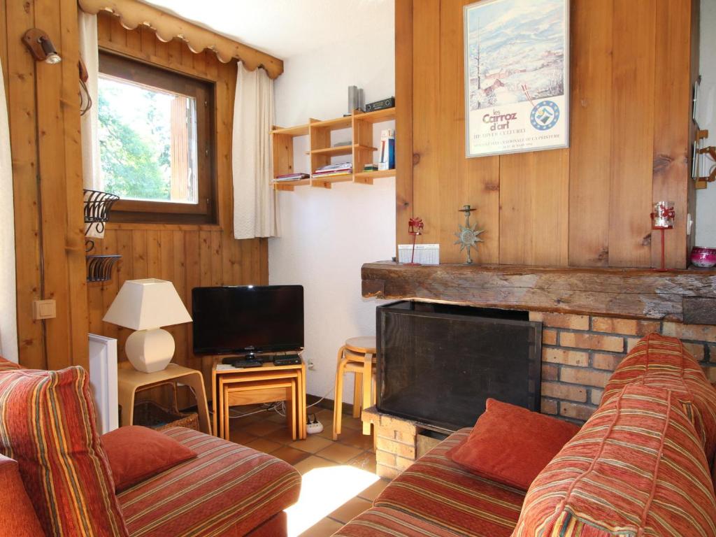 a living room with a couch and a fireplace at Appartement Les Carroz d'Arâches, 4 pièces, 8 personnes - FR-1-572-127 in Arâches-la-Frasse