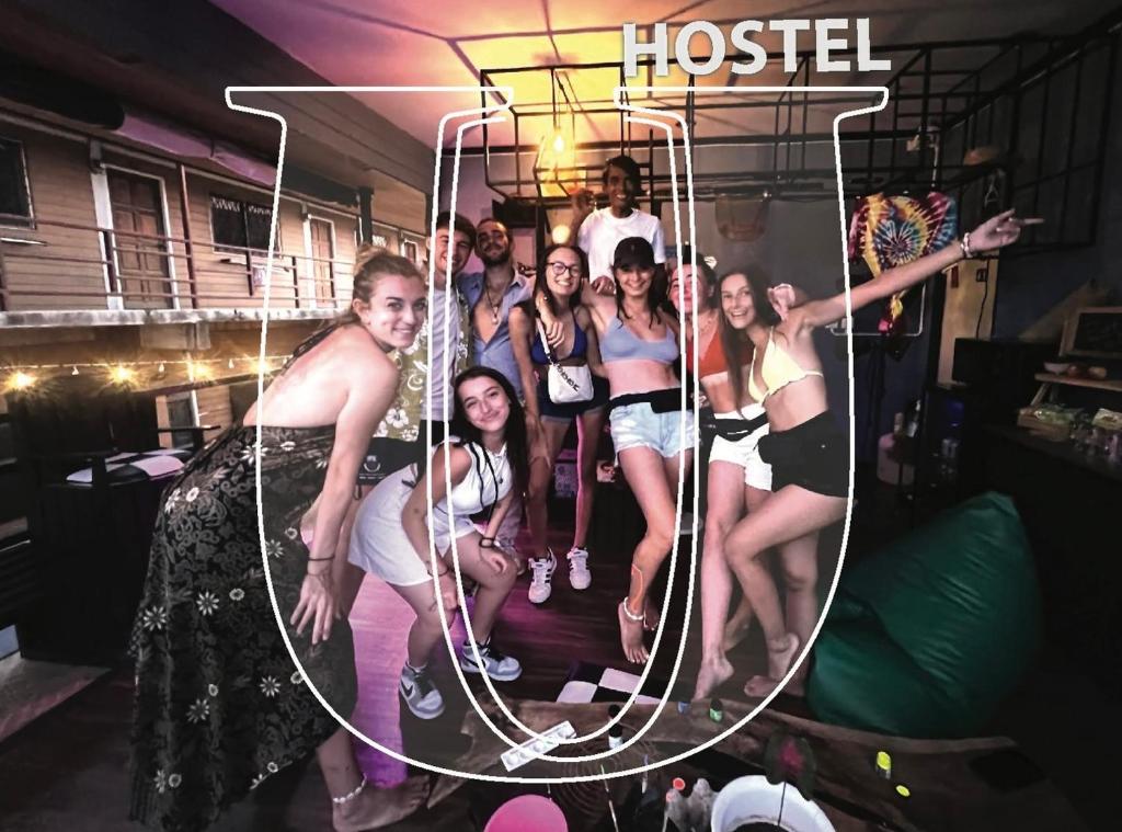 a group of women posing for a picture in a room at U Hostel Koh Phangan in Haad Rin