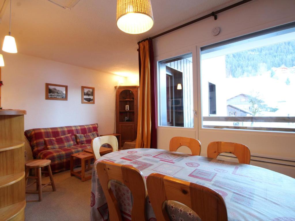 a room with a table and a couch and a window at Appartement Les Carroz d'Arâches, 2 pièces, 6 personnes - FR-1-572-97 in Arâches-la-Frasse