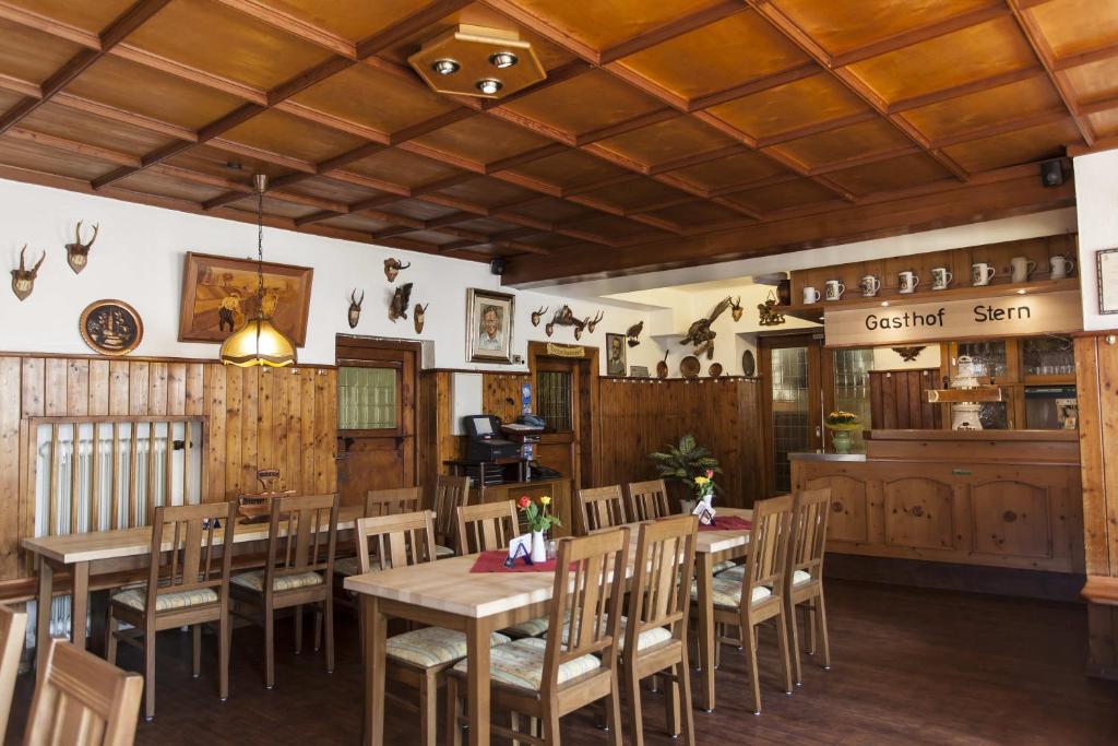 a dining room with wooden tables and chairs at Gasthof Stern in Greding