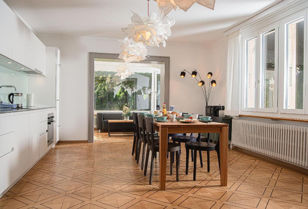 a kitchen and dining room with a table and chairs at Boutique Villa J87 in Interlaken