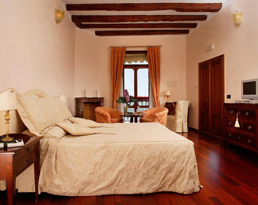 a bedroom with a bed and a living room at La Rosa dei Venti in Venice