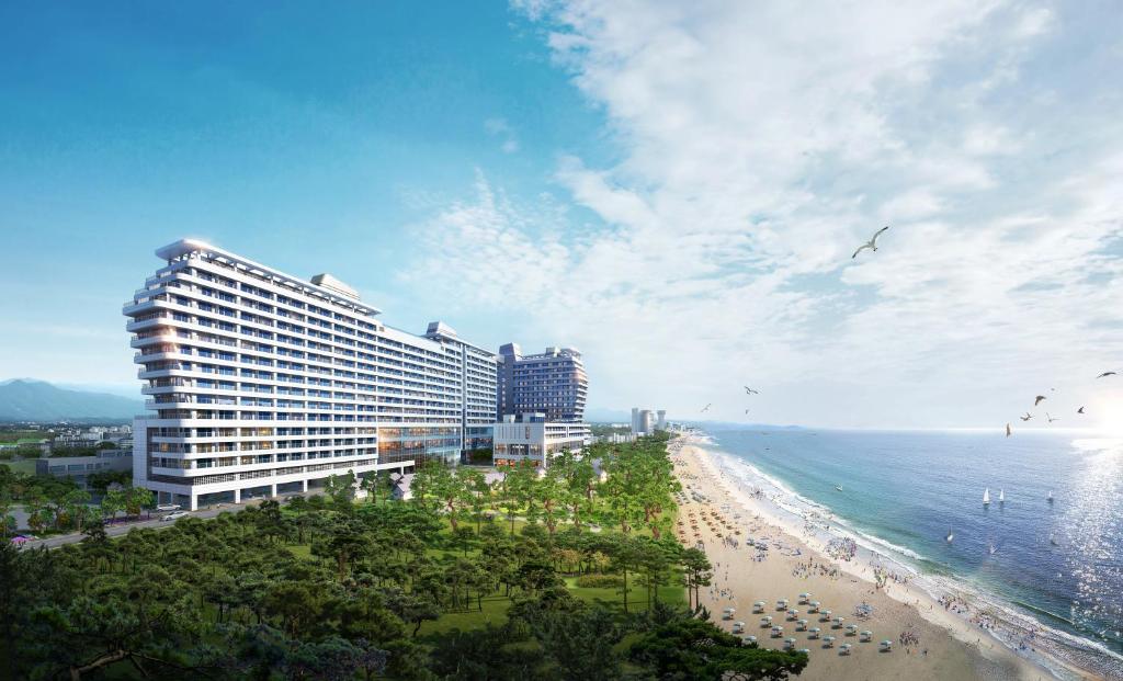 a view of a beach with a hotel and the ocean at St. John's Hotel in Gangneung