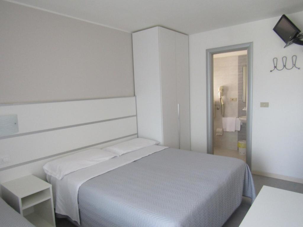 Postel nebo postele na pokoji v ubytování Hotel Atene