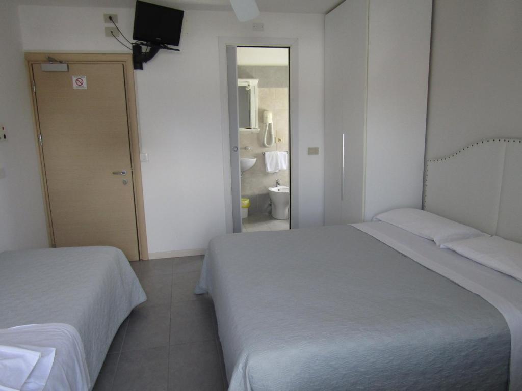 Postel nebo postele na pokoji v ubytování Hotel Atene