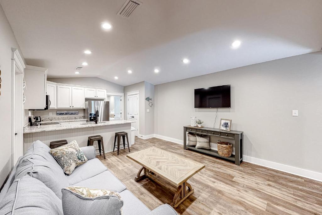 a living room with a couch and a table at Beach Cottage South in Dauphin Island