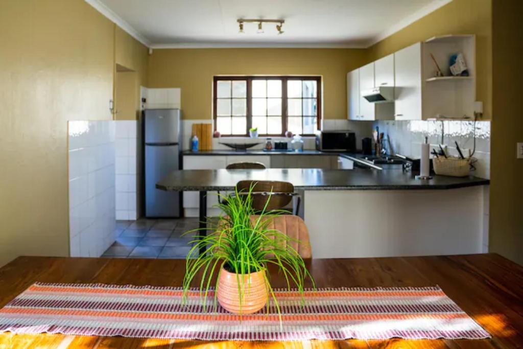 a kitchen with a table and a counter top at Phil's Country Loft- Power backup in Johannesburg