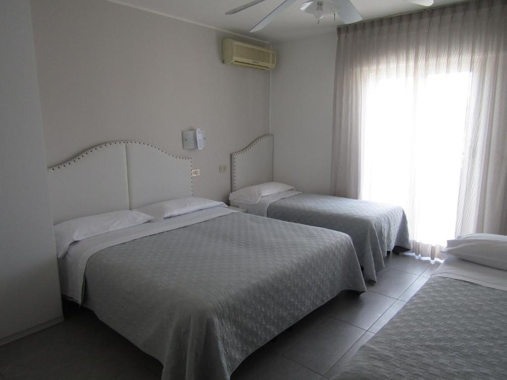 Postel nebo postele na pokoji v ubytování Hotel Atene