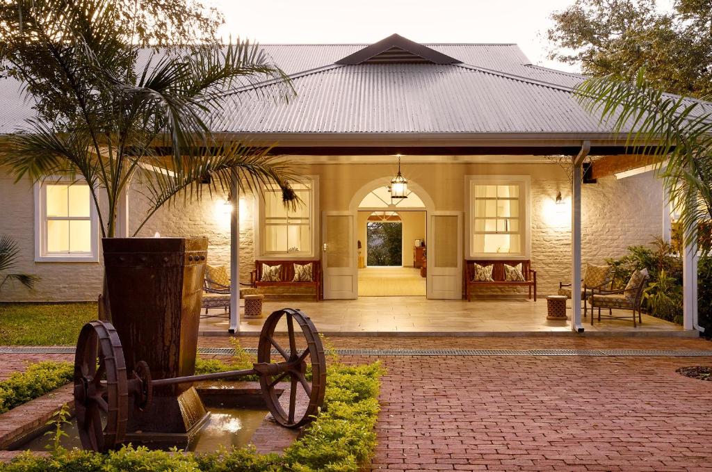 a house with a wheel statue in front of it at Pioneers in Victoria Falls