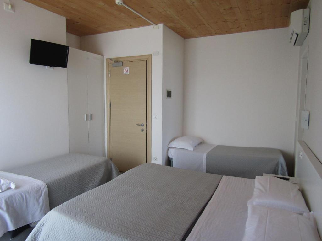 Postel nebo postele na pokoji v ubytování Hotel Atene