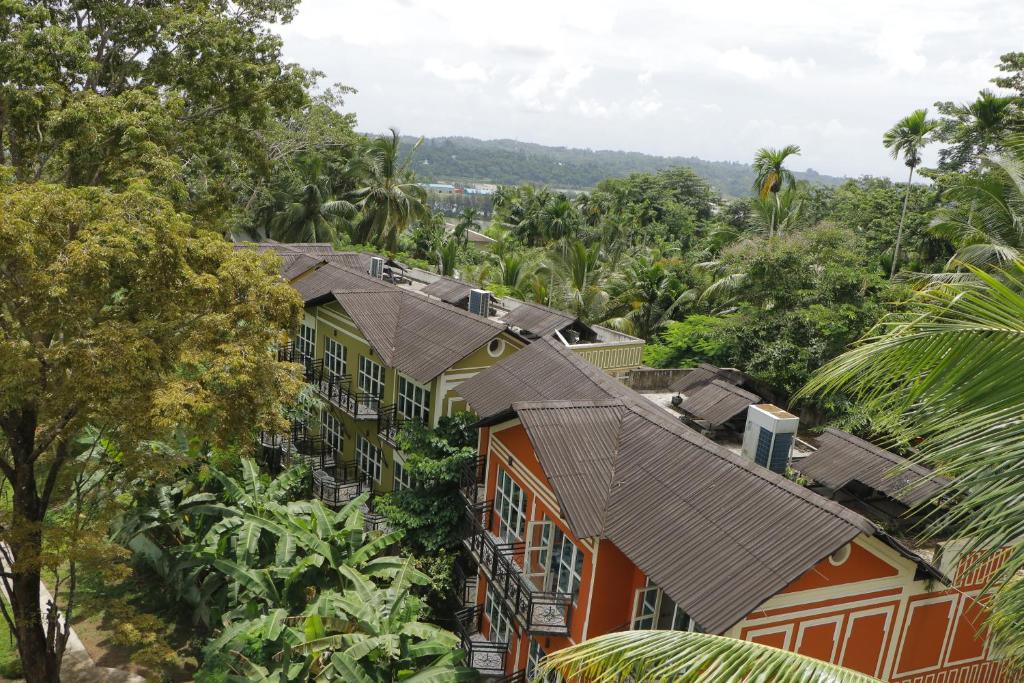 an overhead view of houses in a forest of trees at Clarks Exotica Island House, Portblair in Port Blair