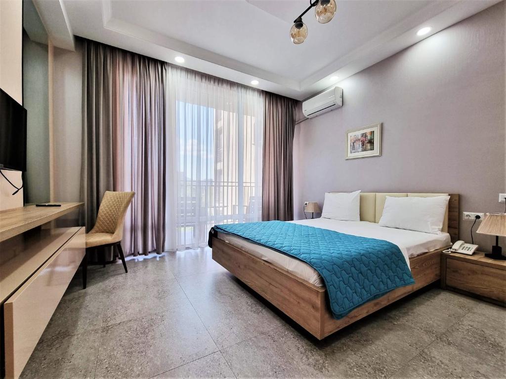 Postel nebo postele na pokoji v ubytování MD Apart Hotel Tbilisi