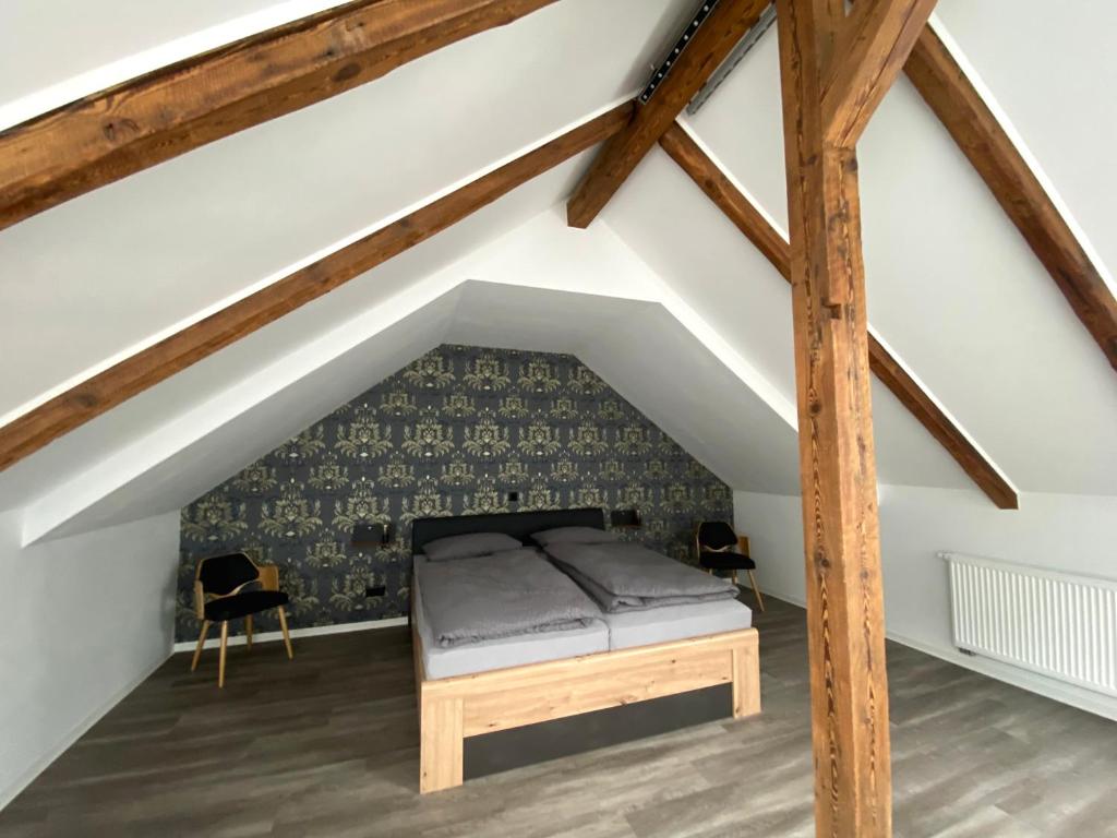a bedroom with a bed in the attic at Ferienwohnungen zur alten PuppenFabrik in Sonneberg
