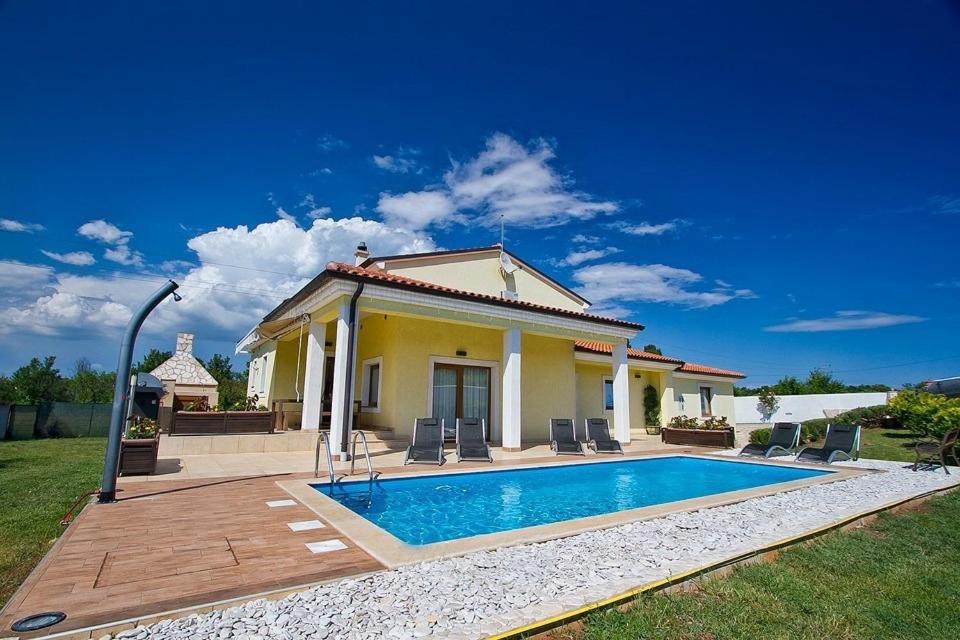 a house with a swimming pool in front of it at Villa MAGGIE in Šišan