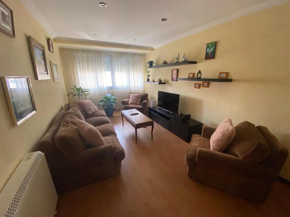 a living room with two couches and a tv at En Gijón y a 2 minutos de playa San Lorenzo in Gijón