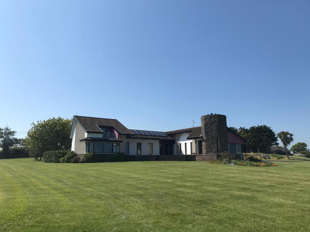 a house with a large lawn in front of it at Castlepoint in Strangford