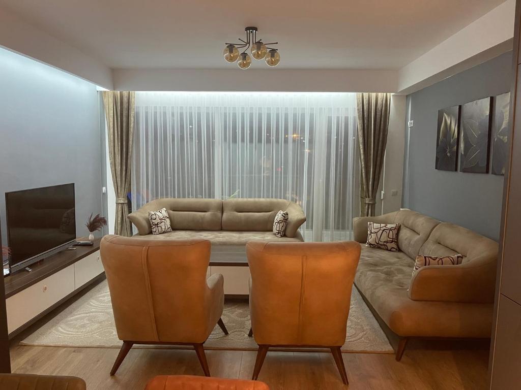 a living room with a couch and a television at DAF apartaments in Pristina