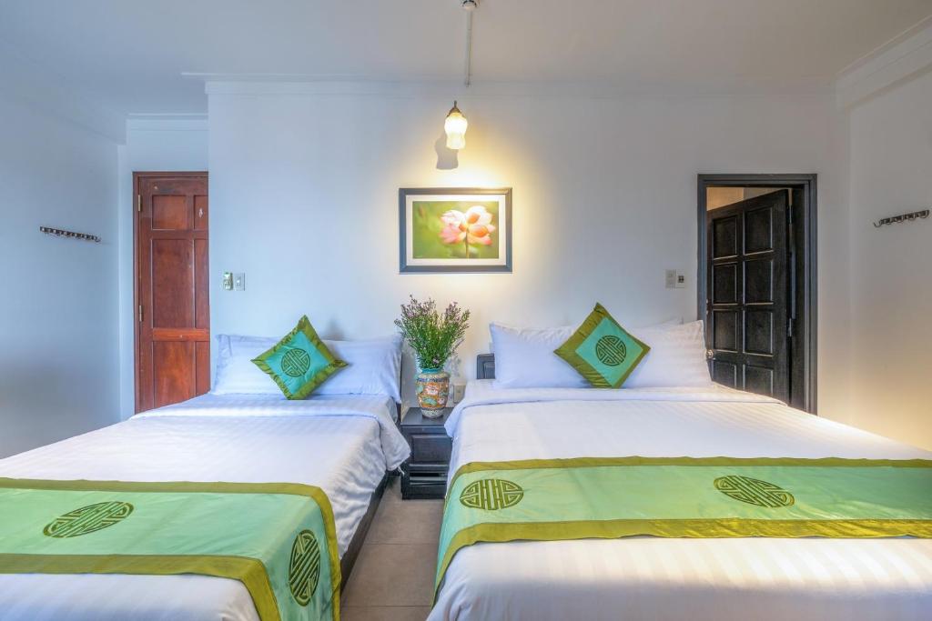 Giường trong phòng chung tại Charming Riverside Hotel