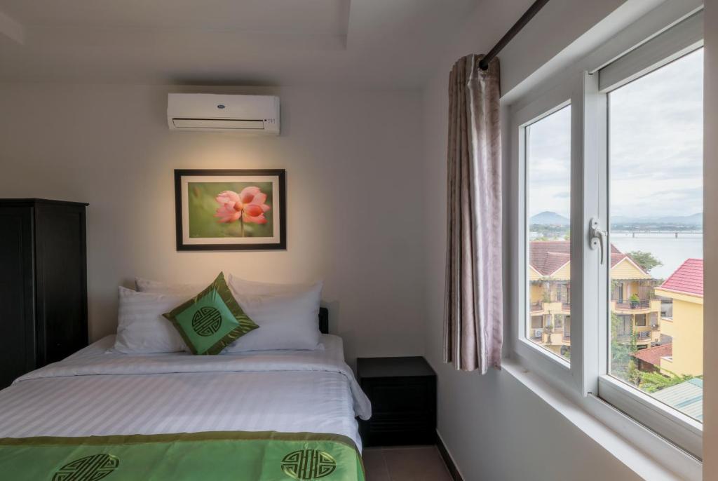 Giường trong phòng chung tại Charming Riverside Hotel