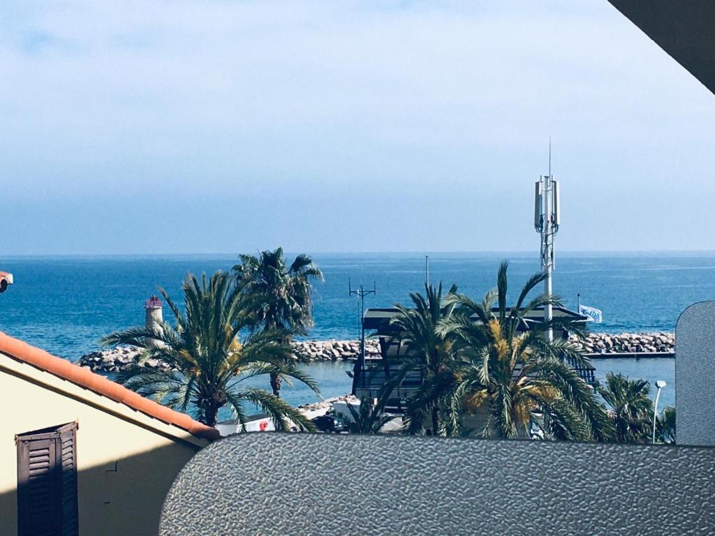 a view of the ocean from the balcony of a building at Gabriella in Menton