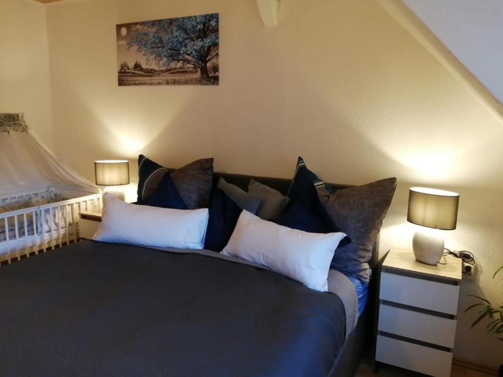 a bedroom with a large bed with two lamps at Ferienwohnung altes Steinlager in Oderberg