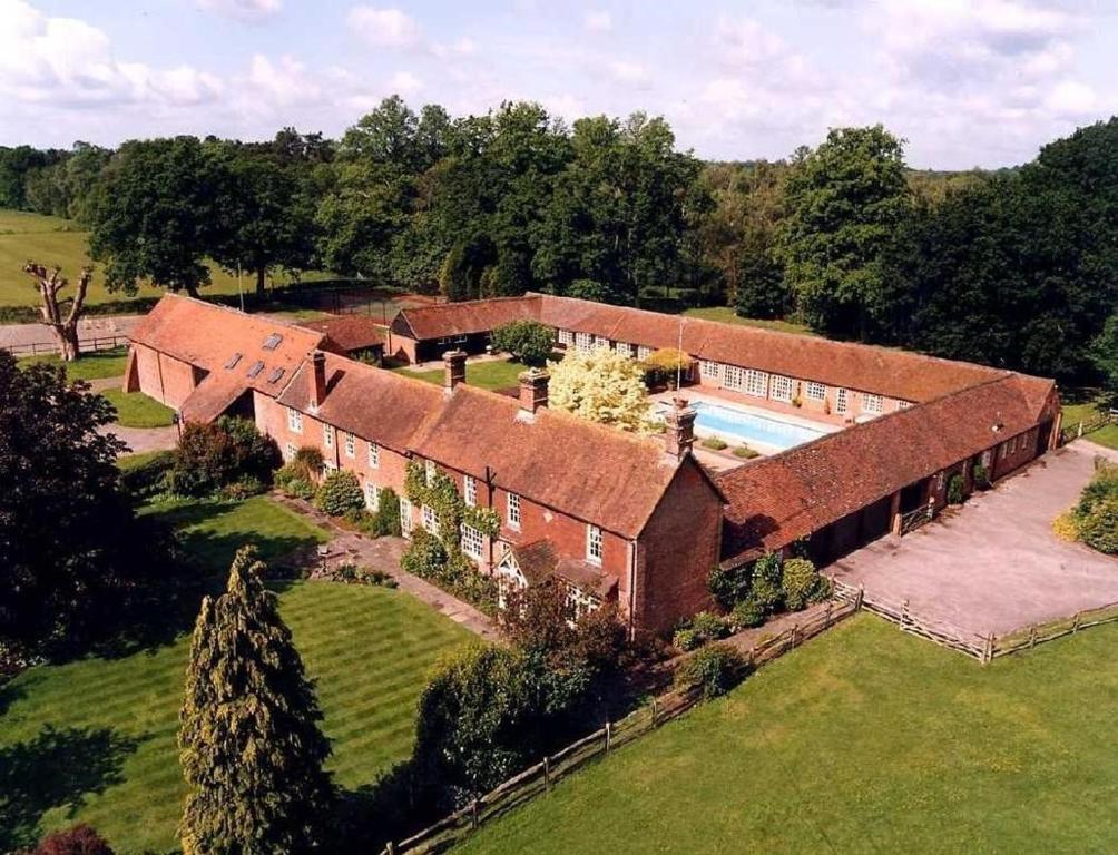 an aerial view of a house with a swimming pool at Whitmoor Farm & Spa in Guildford