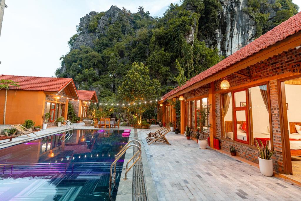 a house with a swimming pool next to a building at Tam Coc mountain bungalow in Ninh Binh