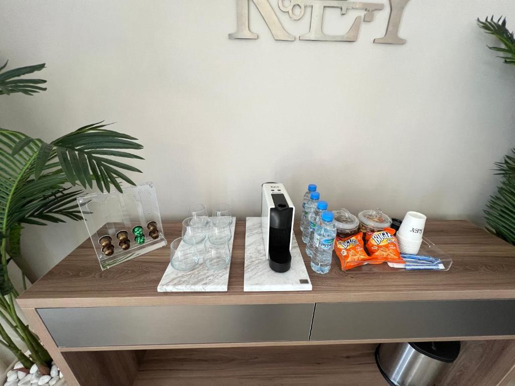 a wooden table with bottles of water and snacks on it at The Key - Luxury Apartment in Doha
