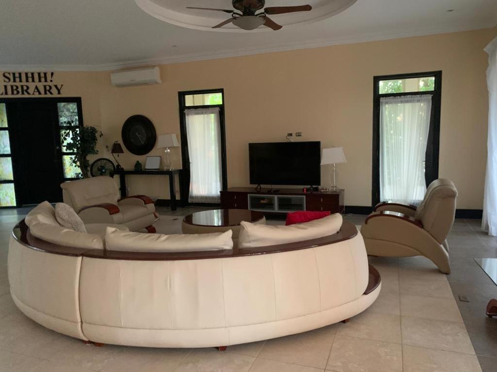 ein großes Wohnzimmer mit einem Sofa und einem TV in der Unterkunft Room in House - Casa De Playa Alegria, Flamingo, in Playa Flamingo