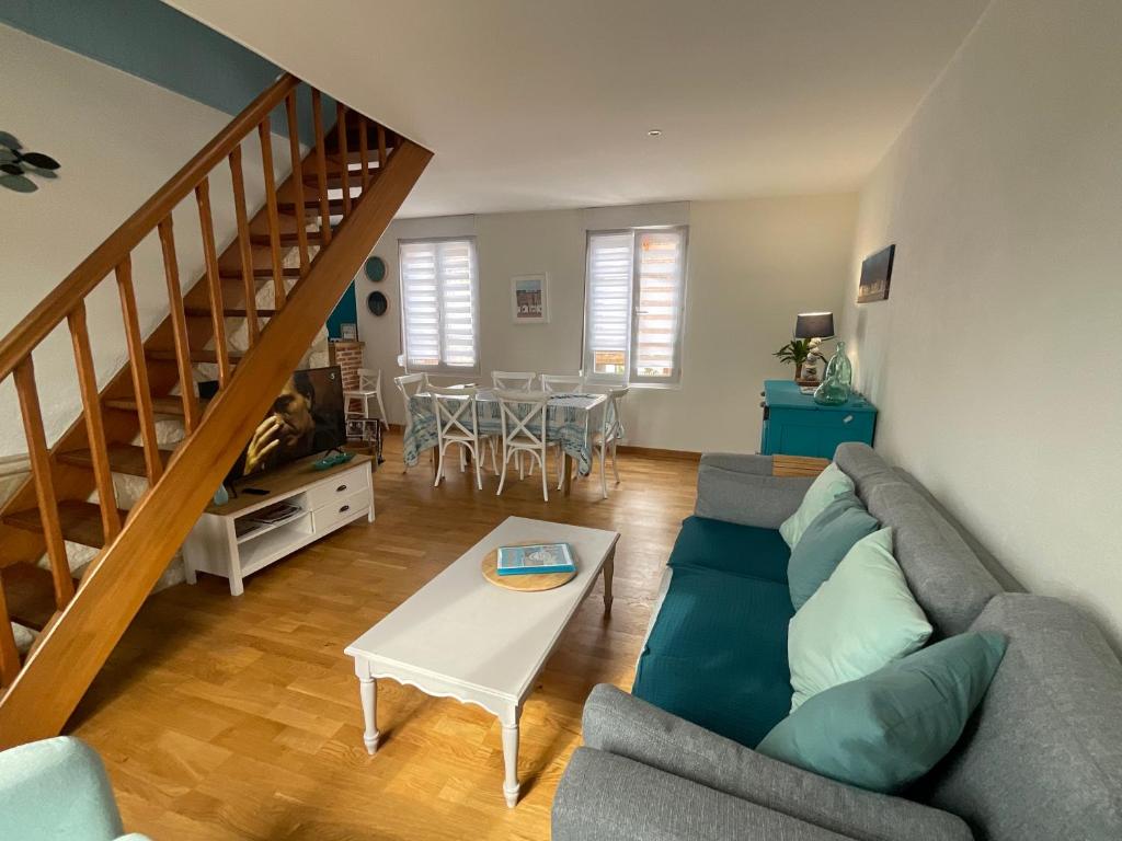 a living room with a couch and a table at le Cottage de la Plage - Maison avec garage in Mers-les-Bains