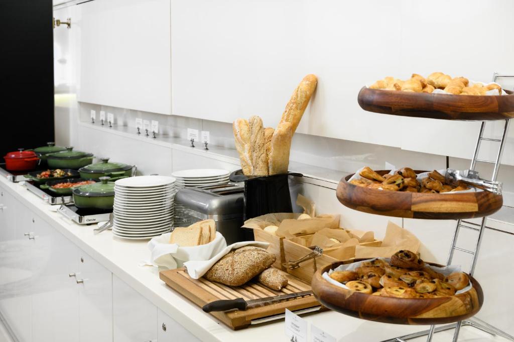 a kitchen with bread and pastries on a counter at Nemzeti Hotel Budapest - MGallery Collection in Budapest