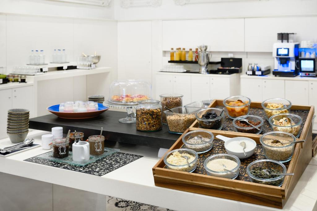 a kitchen with many bowls of food on a counter at Nemzeti Hotel Budapest - MGallery Collection in Budapest