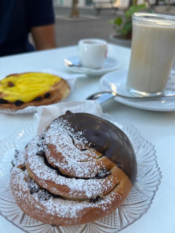 a table with two pastries on a plate on a table at Casa Floris in San Benedetto del Tronto