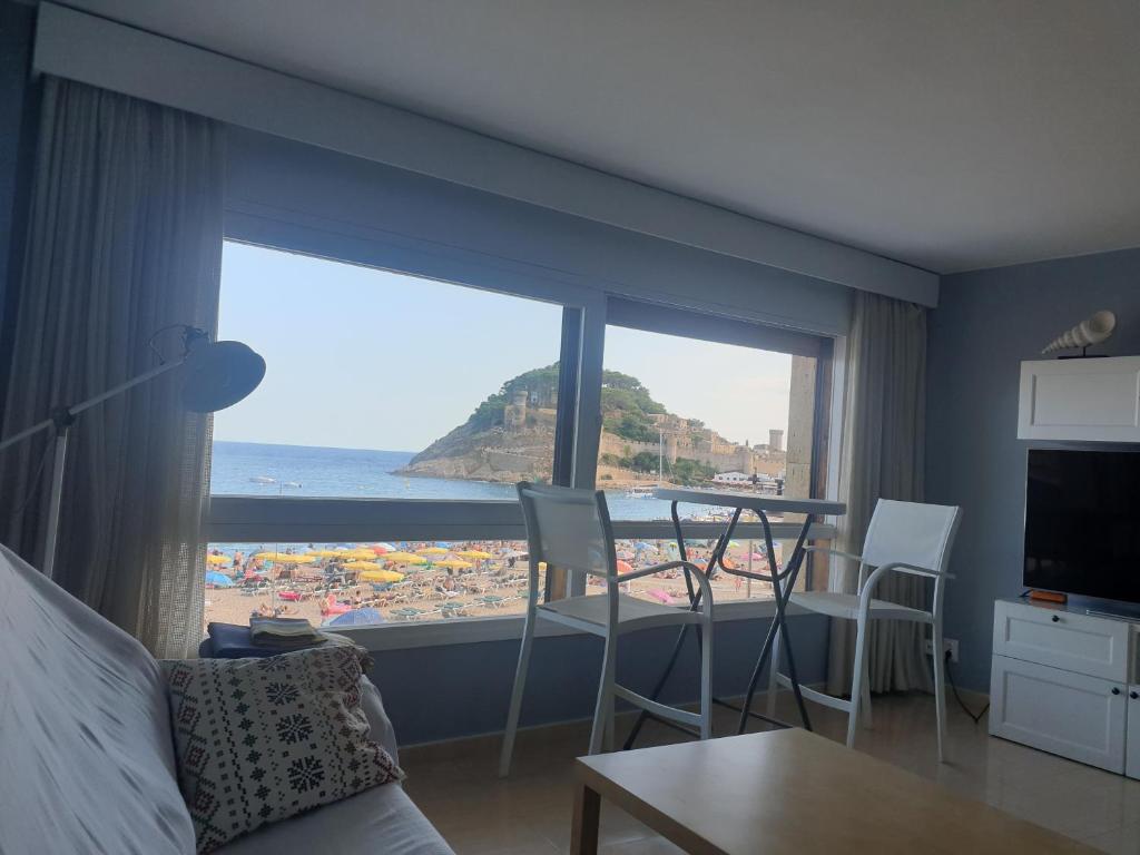 a room with a large window with a view of the ocean at APARTAMENTO EN PRIMERA LINEA DE MAR in Tossa de Mar