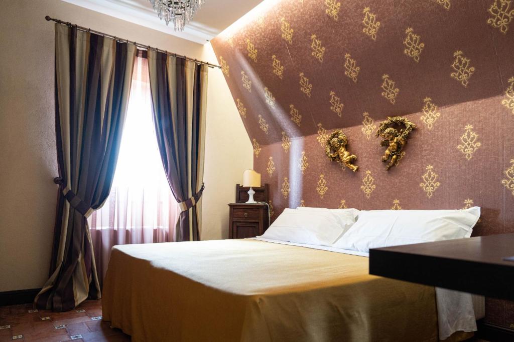 Łóżko lub łóżka w pokoju w obiekcie Hotel Villa Dorata