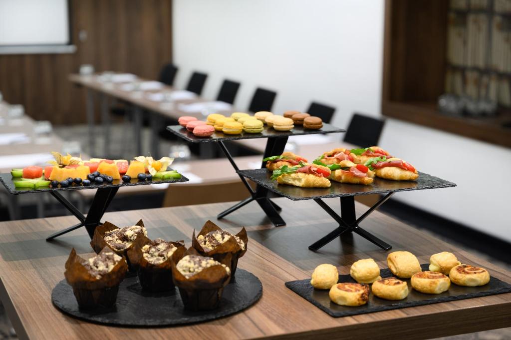a table with three trays of different types of food at Nemzeti Hotel Budapest - MGallery Collection in Budapest