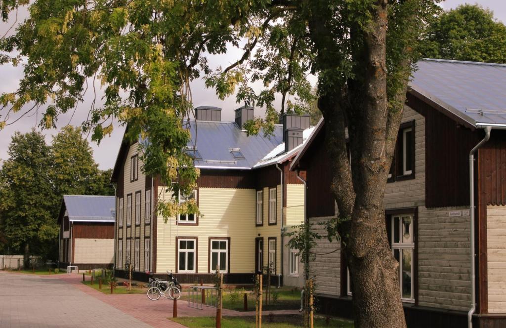 a large white house with a black roof at Aleksi Apartments in Tartu