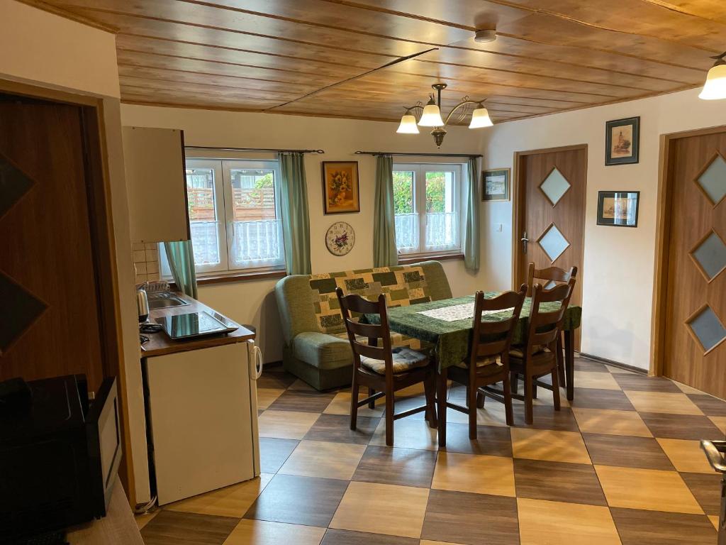 a kitchen and dining room with a table and chairs at Apartments Ve dvoře in Velké Karlovice