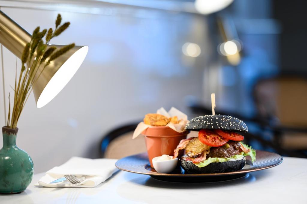 a sandwich on a plate on a table at Nemzeti Hotel Budapest - MGallery Collection in Budapest