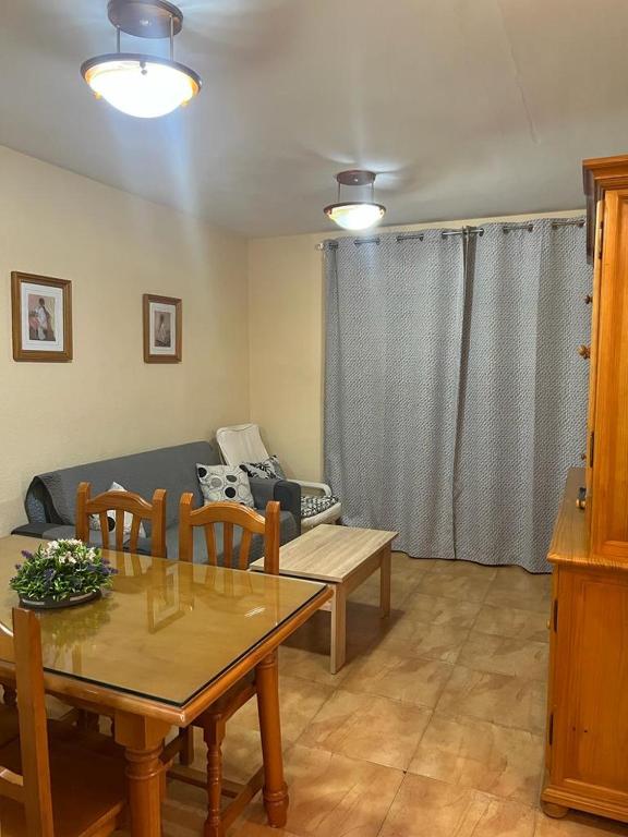 a living room with a table and a couch at Apartamento portil in El Portil